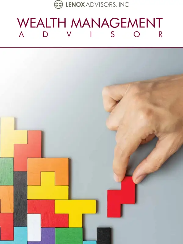 Hand placing puzzle pieces on a gray background.